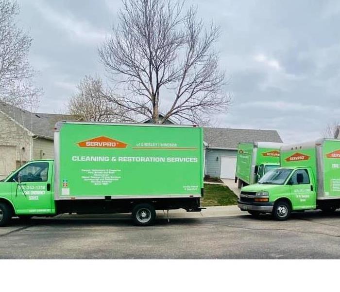 Three Servpro trucks parked outside at a residential loss