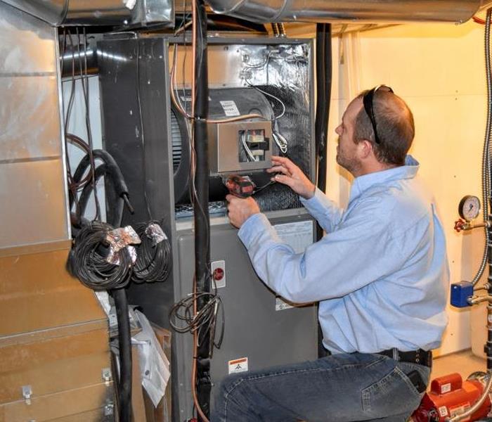 A technician inspecting a furnace